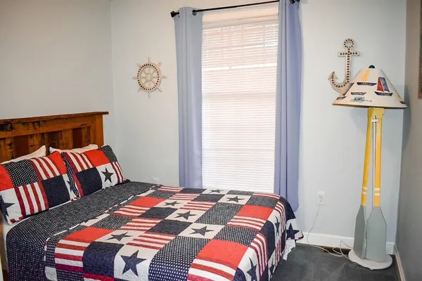 a bedroom with a bed and a window