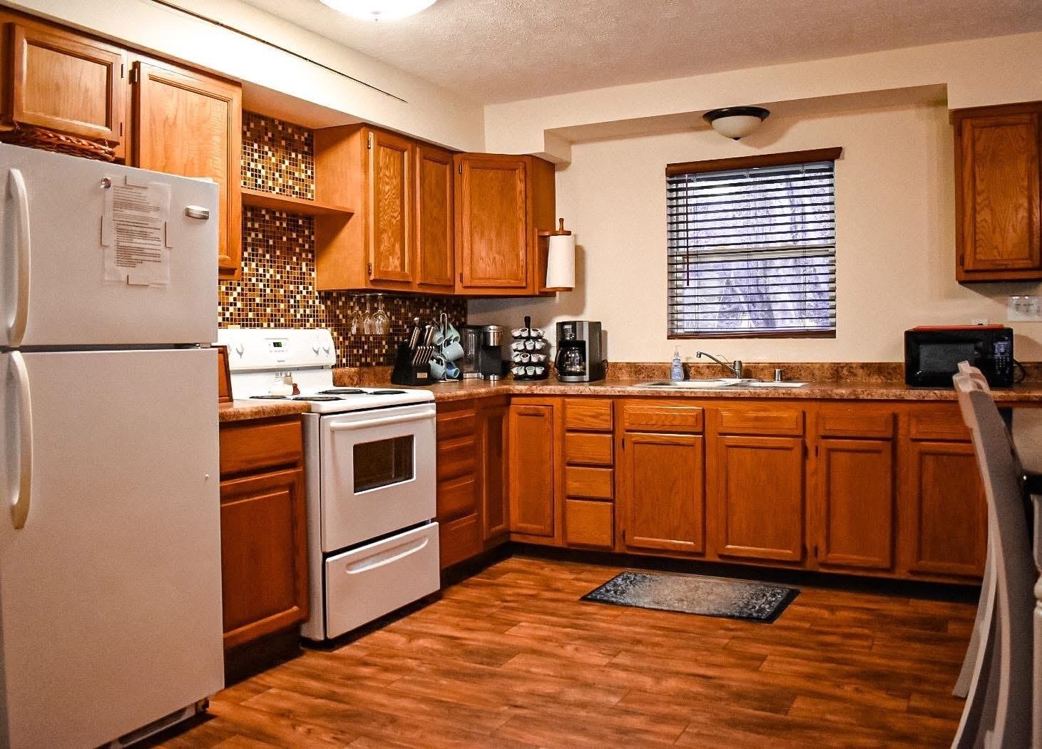 4551 Grove Hill River Road Shenandoah, VA 22849 - Photo 17 of 41 a kitchen with stainless steel appliances granite countertop a stove a sink and a refrigerator