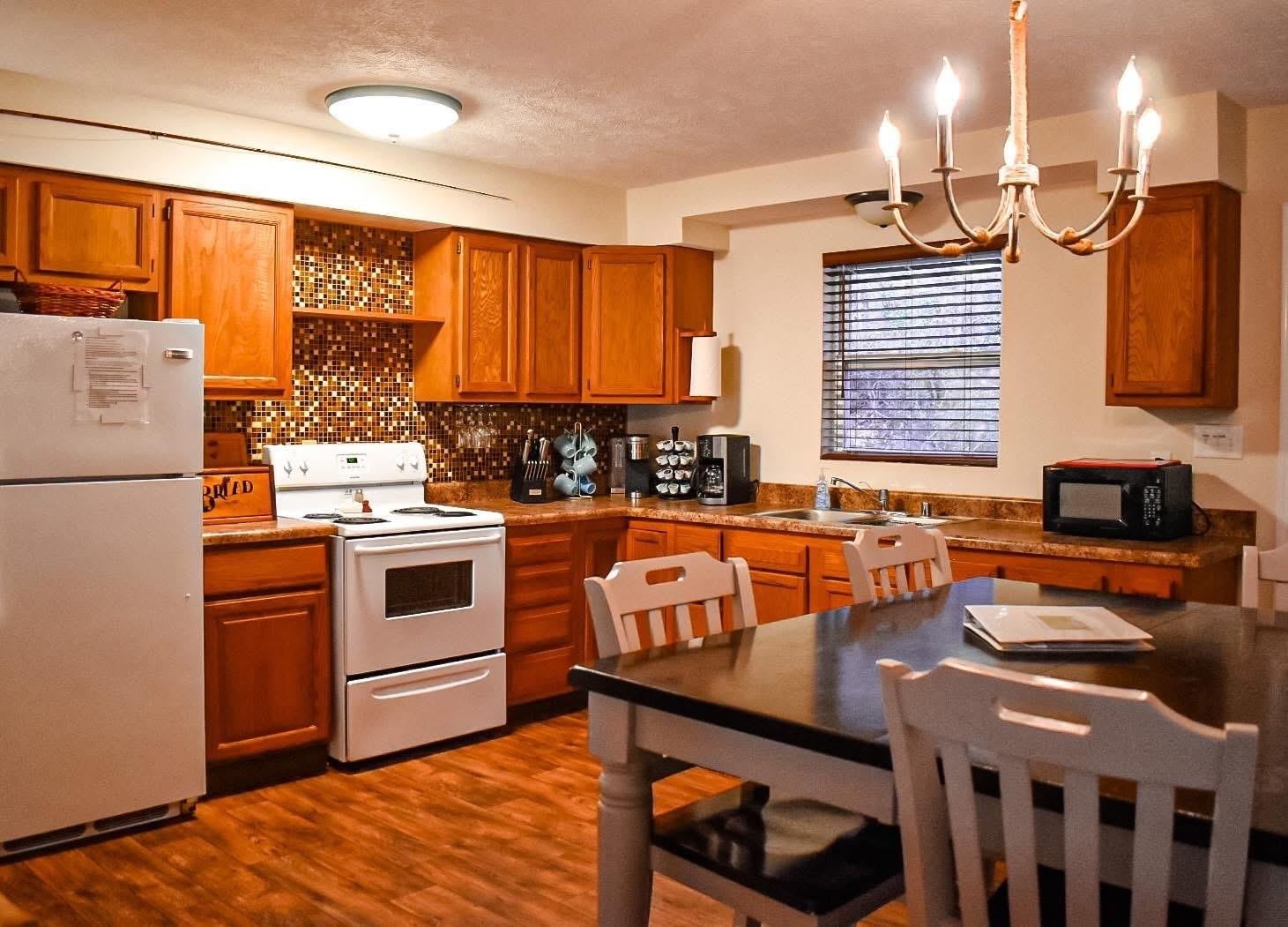4551 Grove Hill River Road Shenandoah, VA 22849 - Photo 19 of 41 a kitchen with stainless steel appliances granite countertop a stove a sink dishwasher and a refrigerator with wooden floor