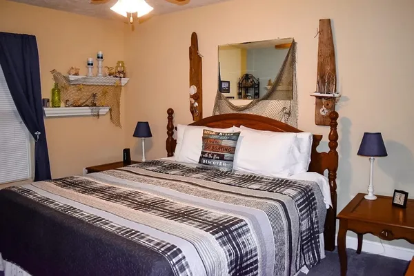 a bedroom with a bed and a chandelier