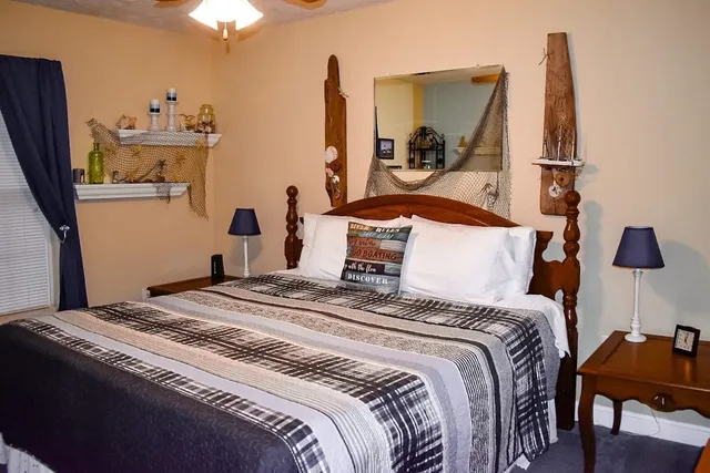 a bedroom with a bed and a chandelier