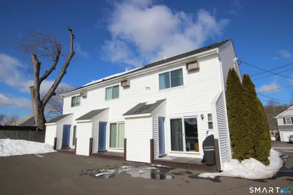 a front view of a house with a road