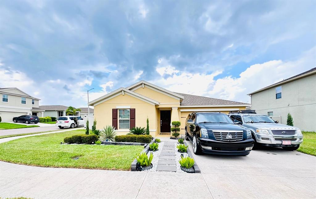 279 Bergamot Loop Davenport, FL 33837 - Photo 1 of 38 a house view with a garden space