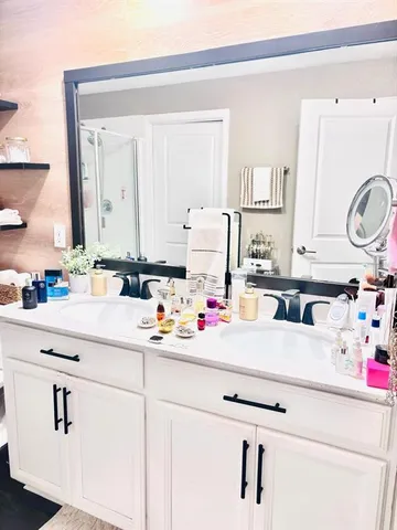 a bathroom with sink cabinets and a mirror