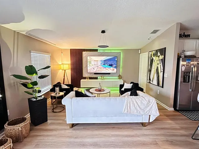 a living room with furniture potted plant and a window