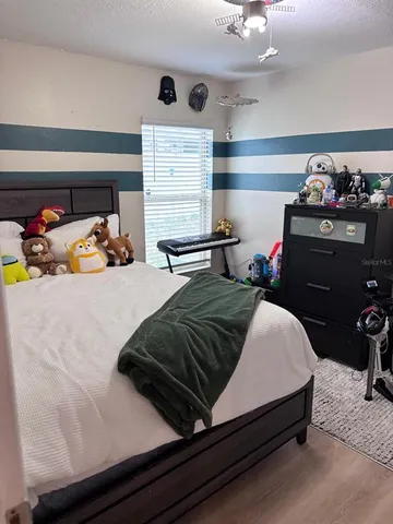 a bedroom with a bed and window