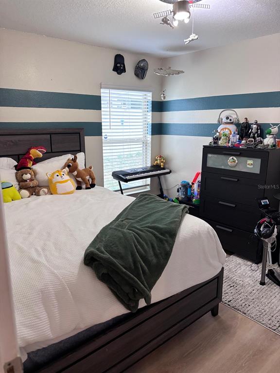 279 Bergamot Loop Davenport, FL 33837 - Photo 16 of 38 a bedroom with a bed and window