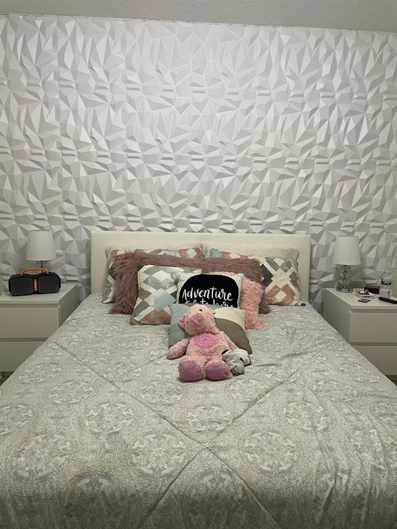 279 Bergamot Loop Davenport, FL 33837 - Photo 21 of 38 a bedroom with a bed and a couch