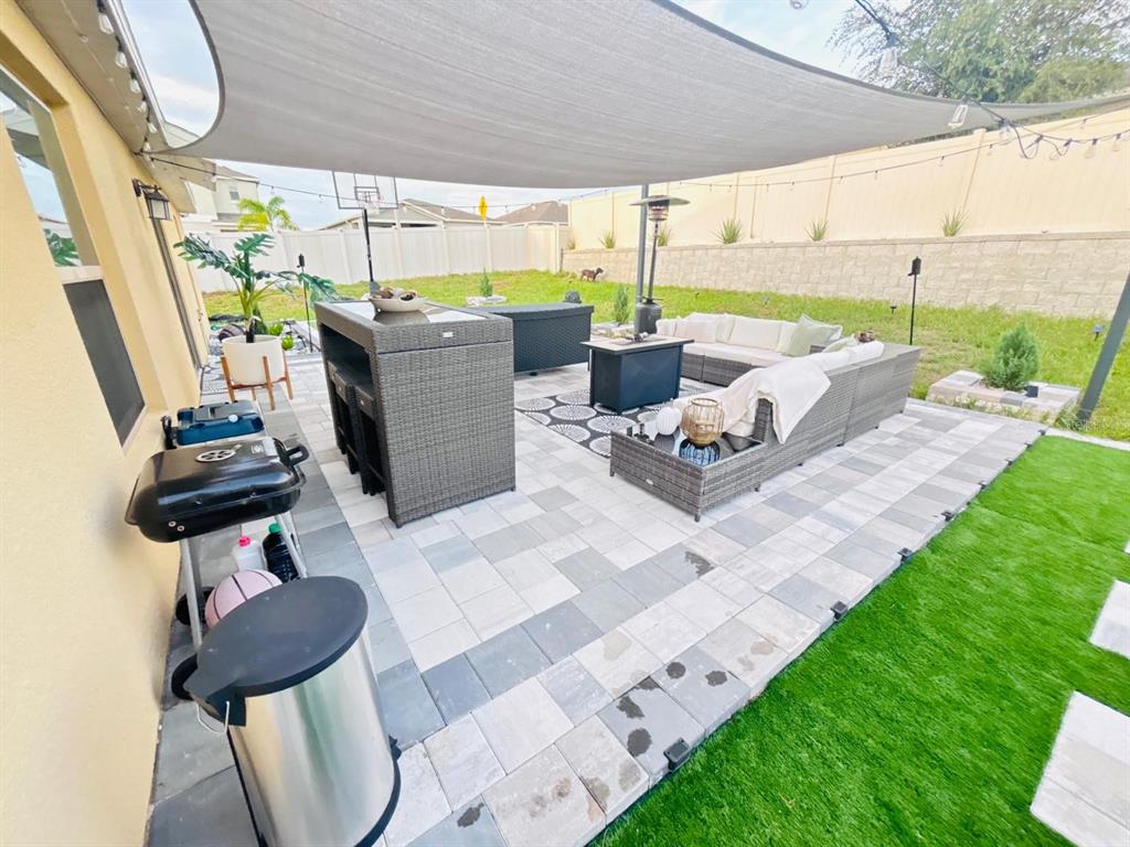 279 Bergamot Loop Davenport, FL 33837 - Photo 27 of 38 a building outdoor space with patio lots of furniture