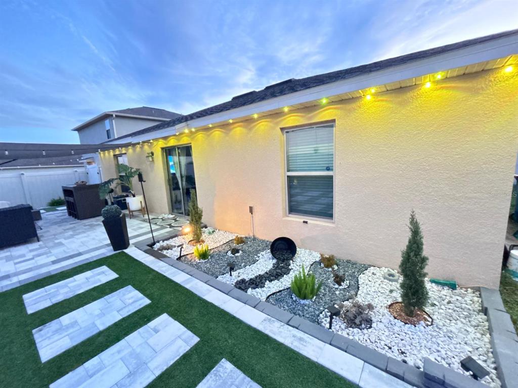 279 Bergamot Loop Davenport, FL 33837 - Photo 28 of 38 a front view of a house with garden view