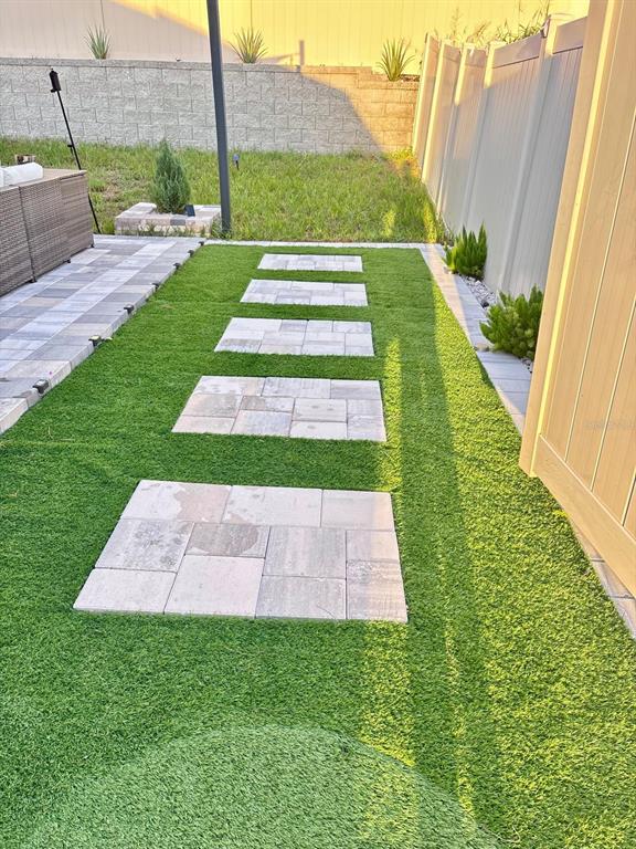 279 Bergamot Loop Davenport, FL 33837 - Photo 29 of 38 a view of a garden with a small yard