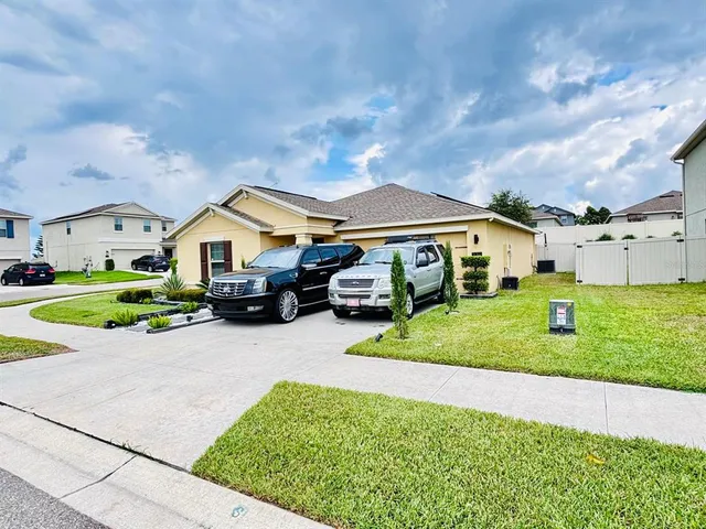 a aerial view of a house with a big yard and large trees