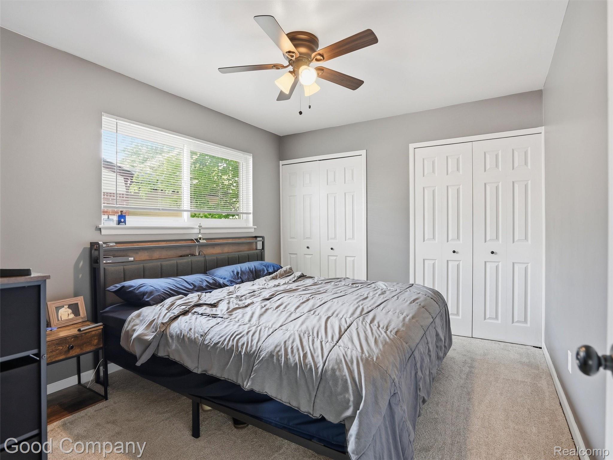 30632 Hayes Road Roseville, MI 48066 - Photo 16 of 32 Carpeted room featuring a ceiling fan with integrated lighting, a broad window with blinds, and two sets of bi-fold closet doors