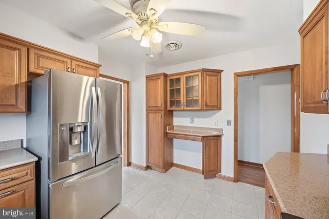 a kitchen with stainless steel appliances a refrigerator and a stove top oven