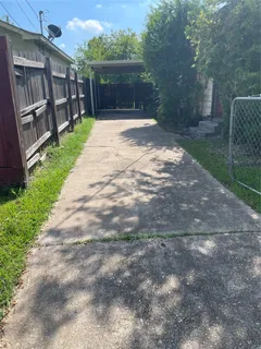 a view of backyard of house and wooden deck