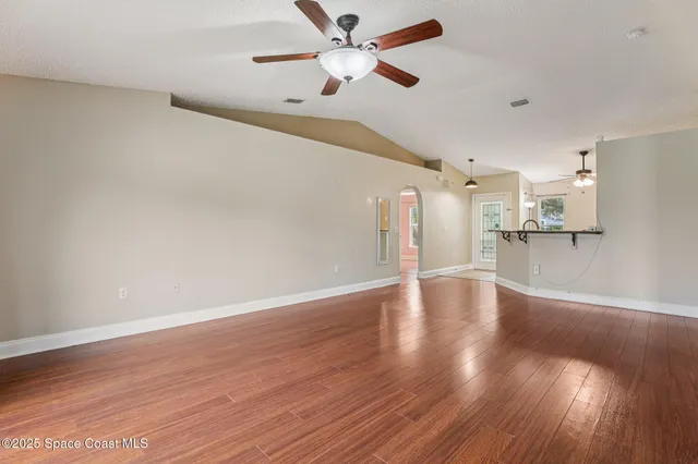 a view of a kitchen with wooden floor and a ceiling fan