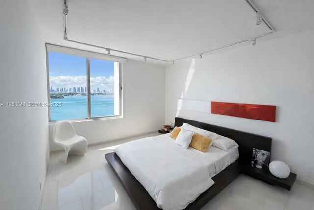 a bedroom with a bed and a couch