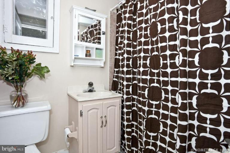 817 Cedarcroft Road Baltimore, MD 21212 - Photo 22 of 28 a view of a bathroom with a sink and a mirror