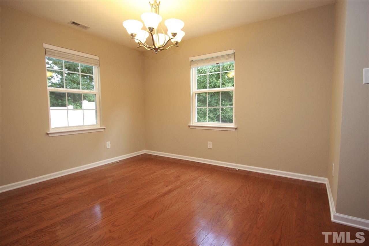 8902 Thornton Garden Lane Raleigh, NC 27616 - Photo 11 of 23 an empty room with wooden floor and windows