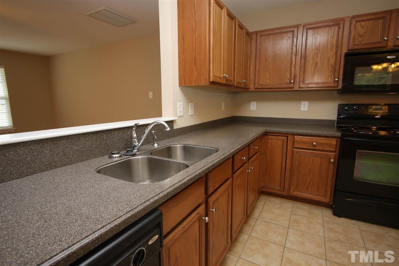 8902 Thornton Garden Lane Raleigh, NC 27616 - Photo 13 of 23 a kitchen with granite countertop a sink and cabinets