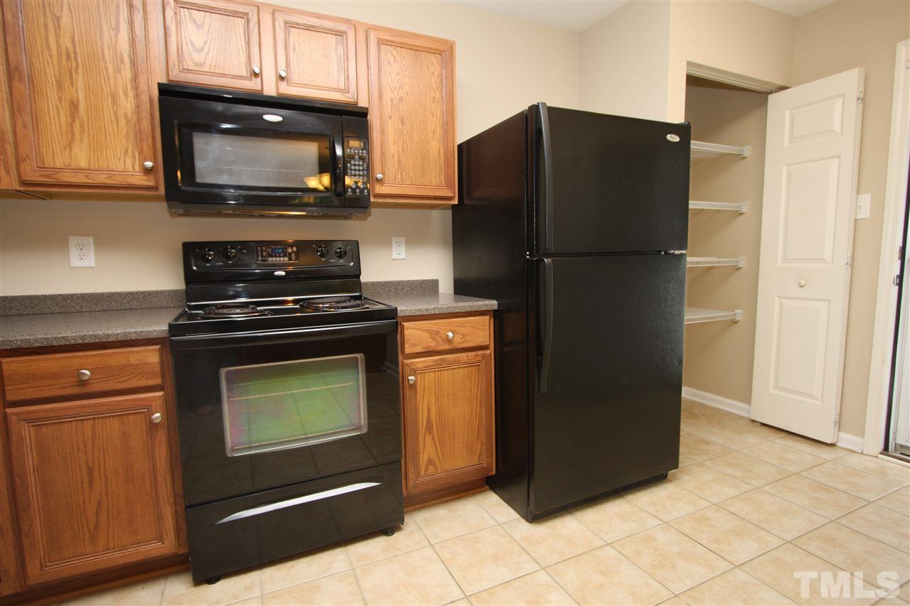 8902 Thornton Garden Lane Raleigh, NC 27616 - Photo 14 of 23 a kitchen with a refrigerator stove and microwave
