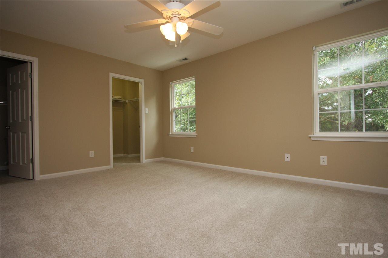 8902 Thornton Garden Lane Raleigh, NC 27616 - Photo 16 of 23 an empty room with windows and fan
