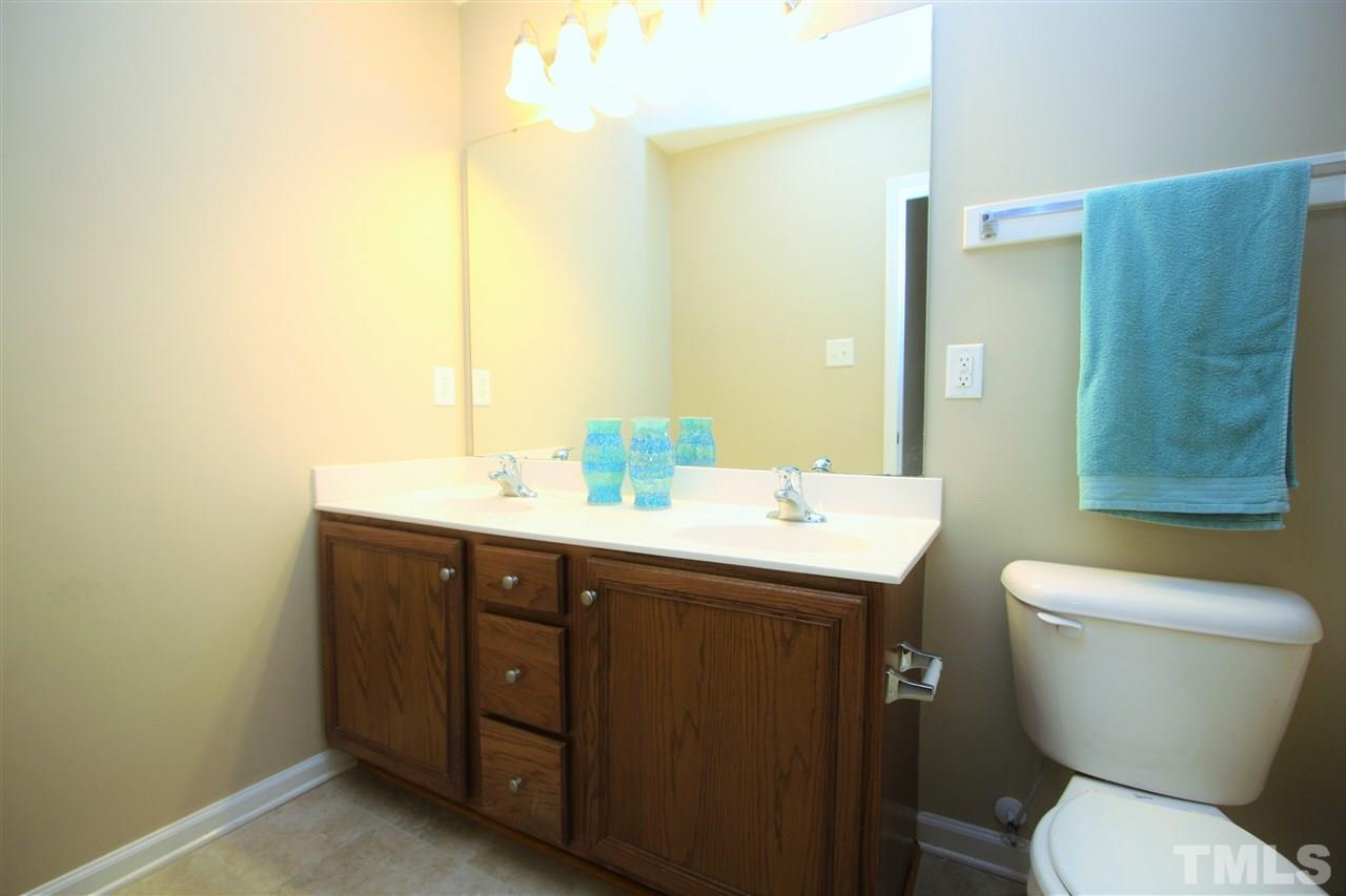 8902 Thornton Garden Lane Raleigh, NC 27616 - Photo 18 of 23 a bathroom with a toilet sink and mirror