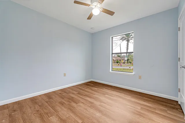 wooden floor in an empty room with a window