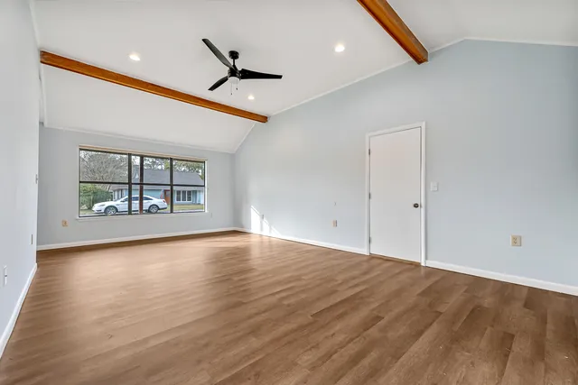 wooden floor in an empty room with a window
