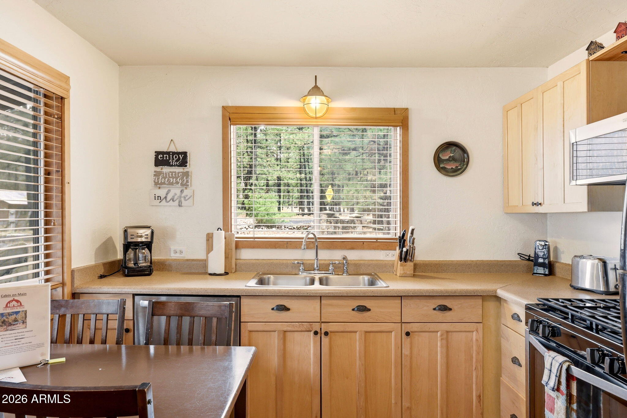 41 Main Street Greer, AZ 85927 - Photo 12 of 30 a kitchen with stainless steel appliances granite countertop a stove a sink dishwasher and cabinets with wooden floor