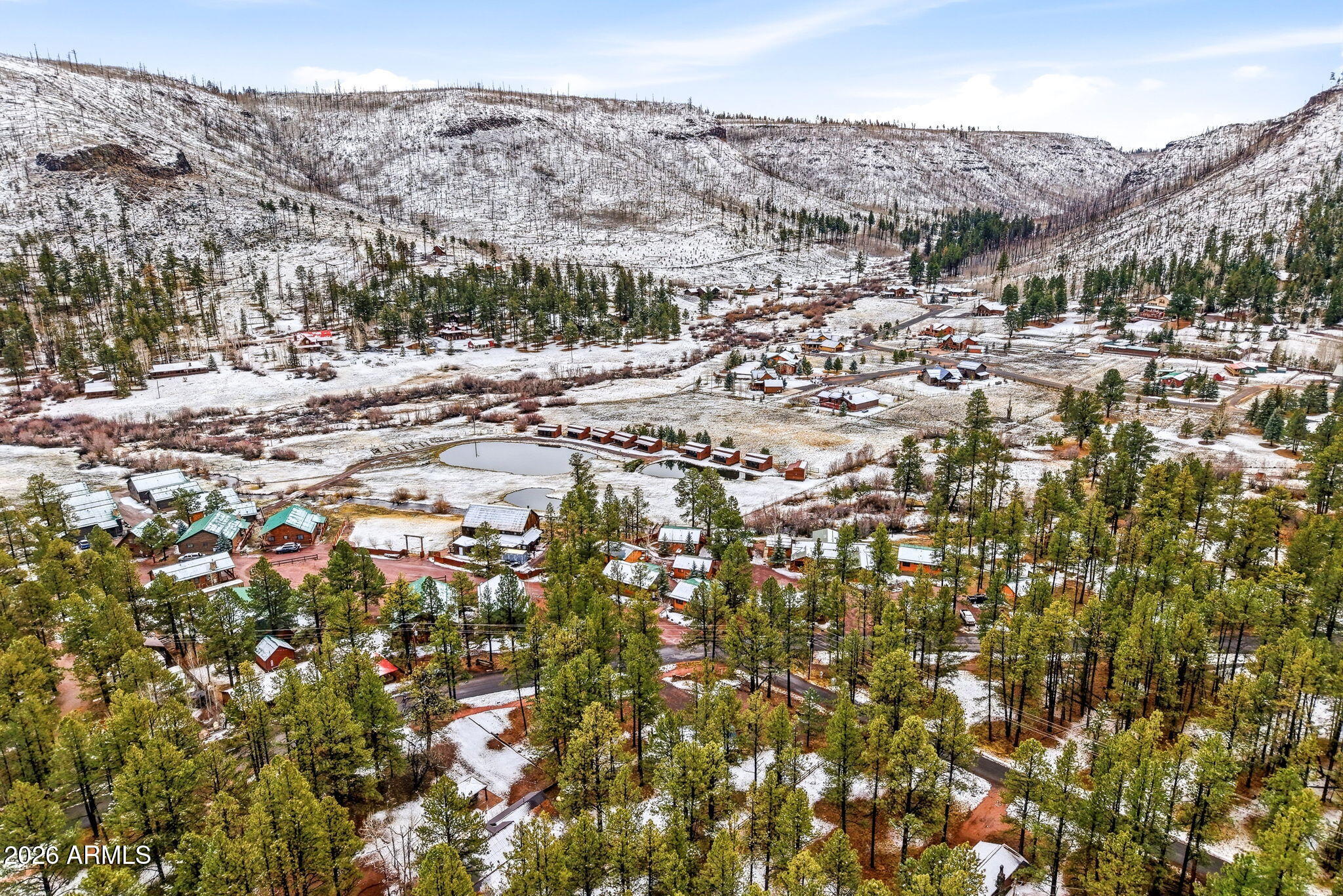 41 Main Street Greer, AZ 85927 - Photo 26 of 30 a view of a town with mountains in the background