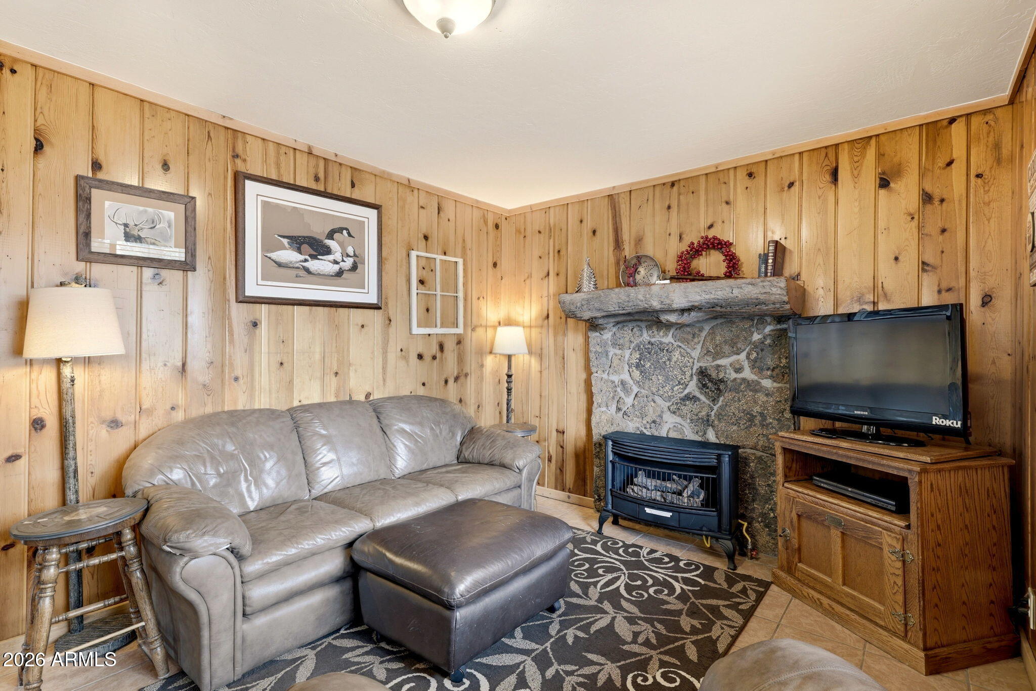41 Main Street Greer, AZ 85927 - Photo 8 of 30 a living room with furniture a fireplace and a flat screen tv