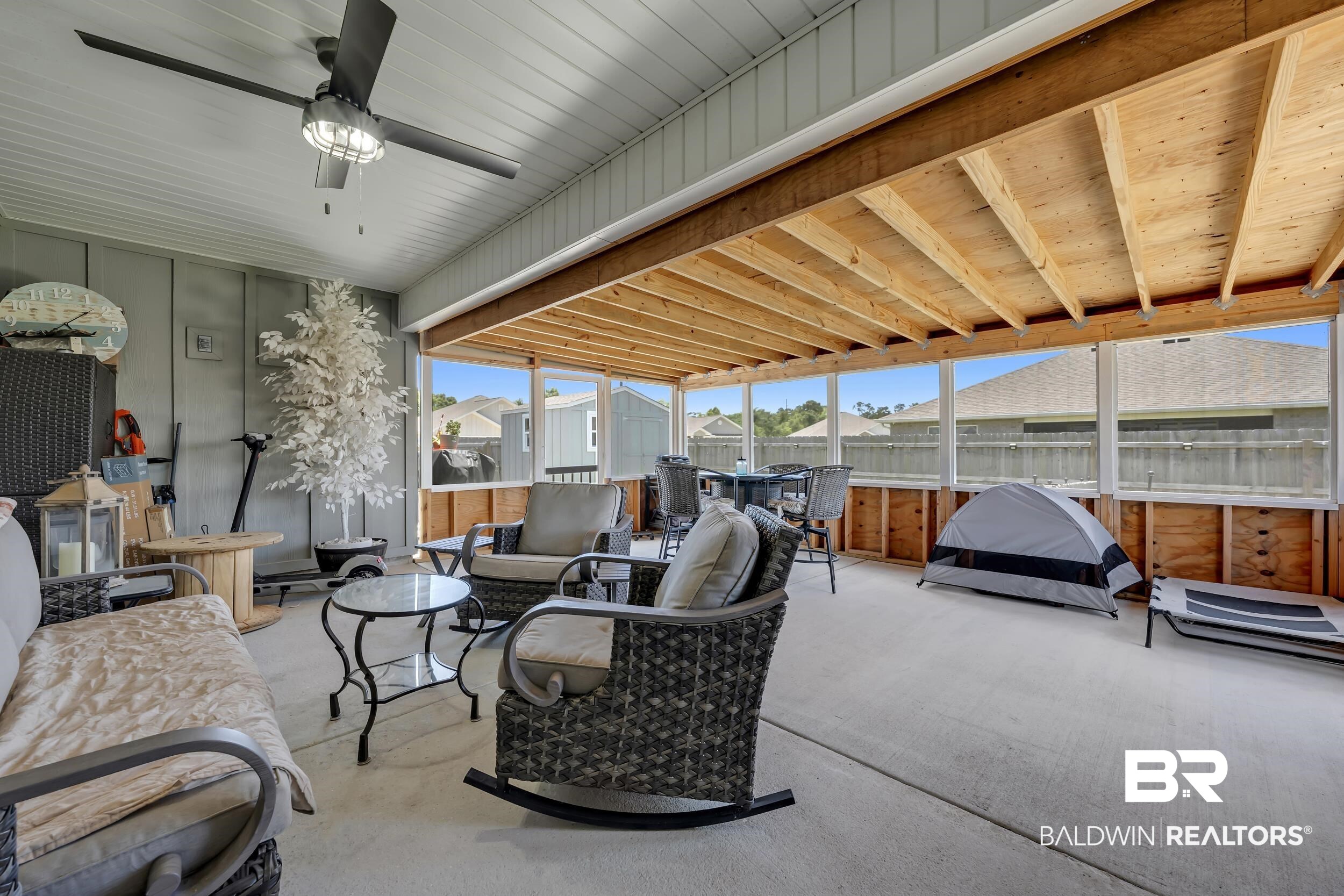 24271 Ringneck Loop Elberta, AL 36530 - Photo 31 of 44 Expansive screened porch featuring a vaulted ceiling with exposed wood joists, a ceiling fan, and concrete flooring