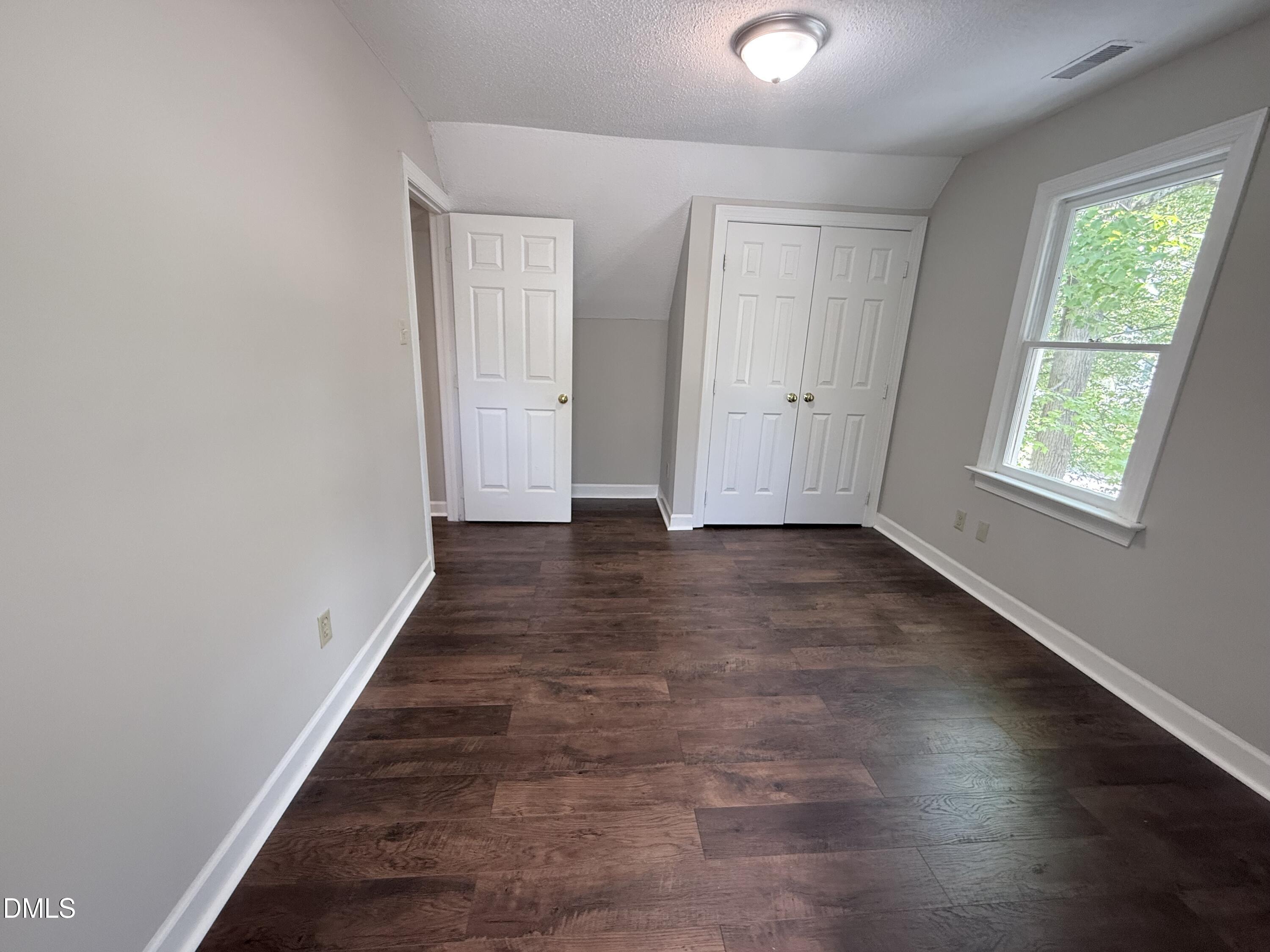 2900 Broadlands Drive Raleigh, NC 27604 - Photo 53 of 60 an empty room with wooden floor and windows