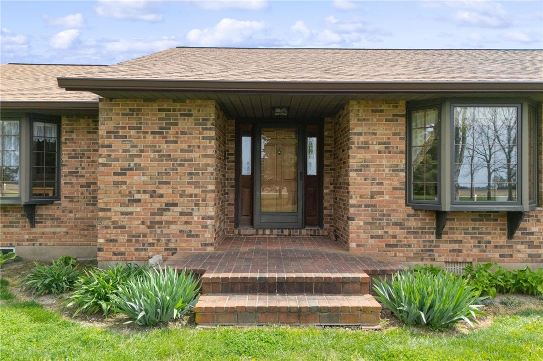 4971 Lackey Road Cedarville, OH 45314 - Photo 15 of 79 This classic brick residence features a welcoming entrance, complemented by lush greenery.