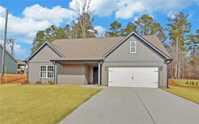 a view of garage with a garden