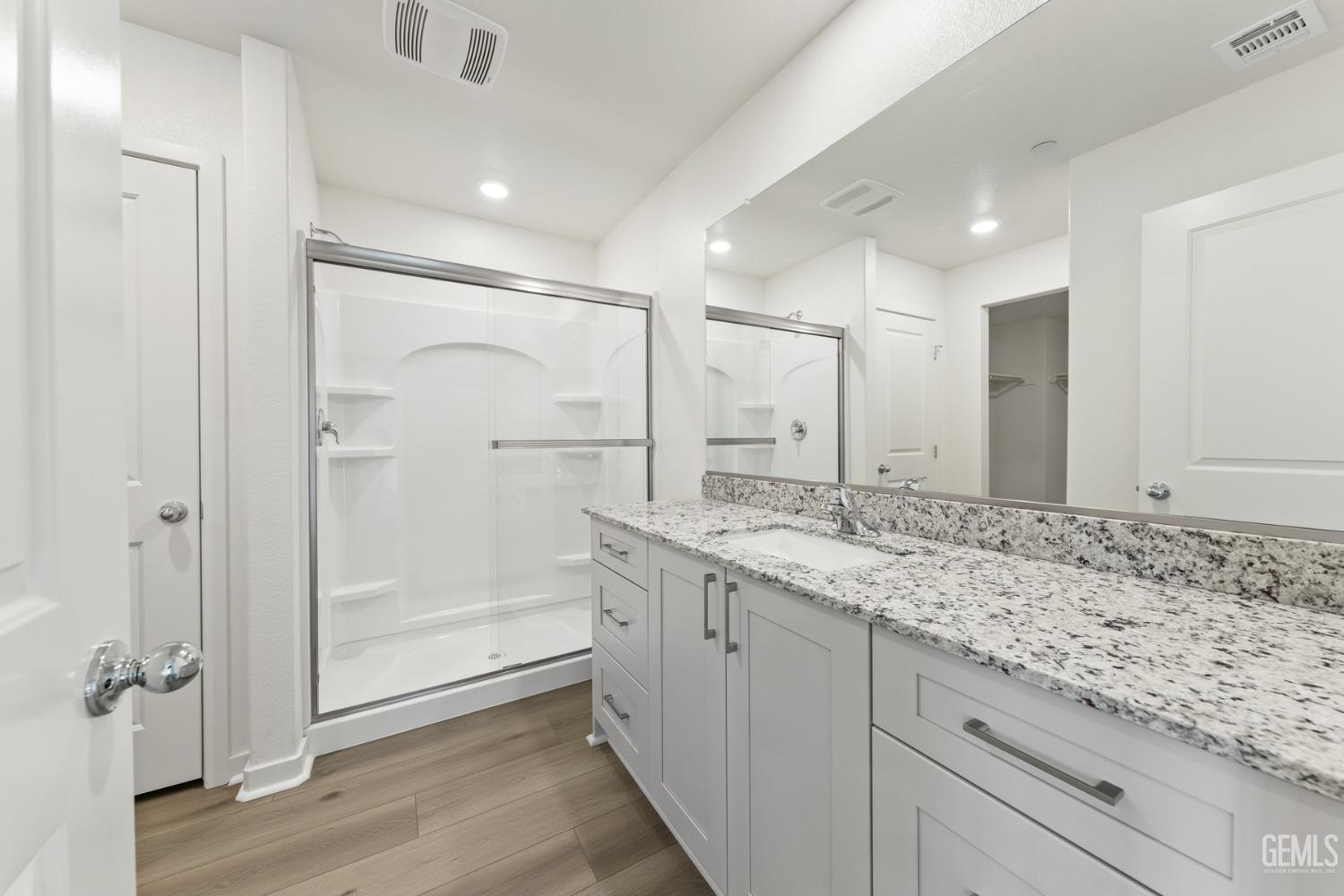 Undisclosed Address Bakersfield, CA 93313 - Photo 5 of 12 a bathroom with a granite countertop sink mirror and shower