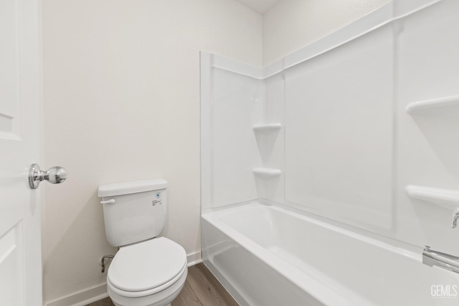 Undisclosed Address Bakersfield, CA 93313 - Photo 9 of 12 a white toilet sitting next to a bath tub