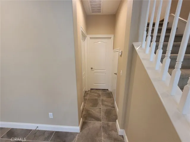 view of a hallway with wooden floor and staircase