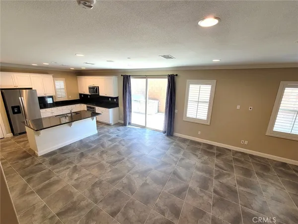 a view of a livingroom with wooden floor and furniture