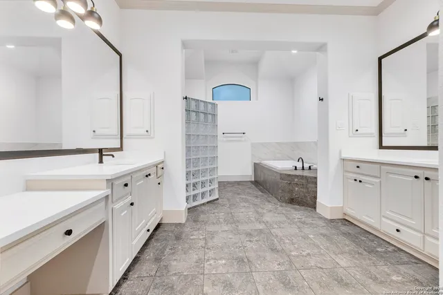 a spacious bathroom with double sink and a mirror