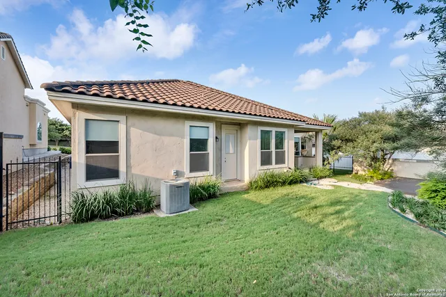 a front view of house with yard and green space