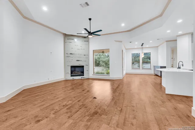 a view of an empty room with window and cabinet