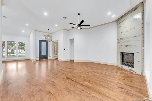 a view of an empty room with a fireplace and a window