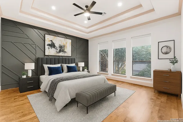 a bedroom with a large bed and a chandelier