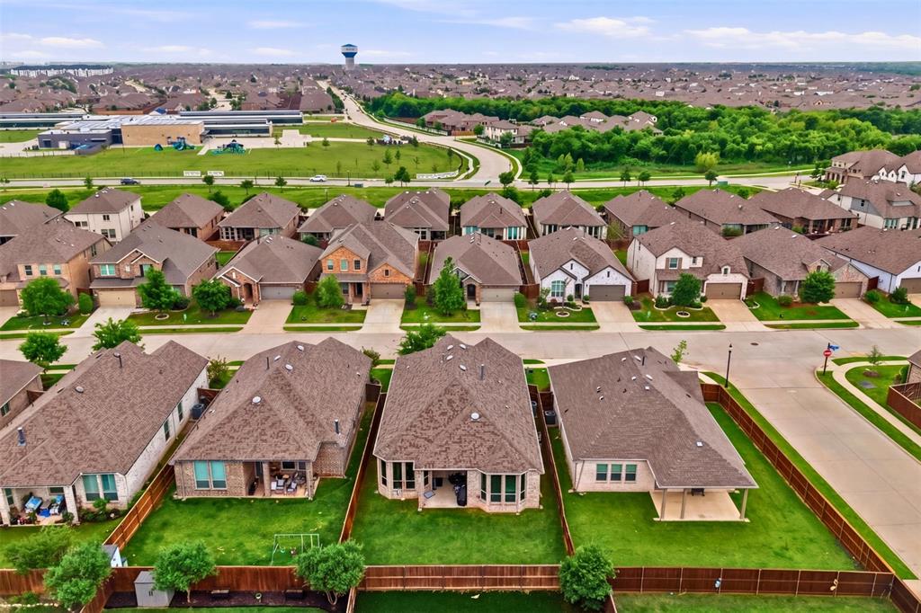 1429 Eclipse Road Aubrey, TX 76227 - Photo 30 of 37 An aerial view of the property, showcasing its well-maintained lawn and private fenced yard