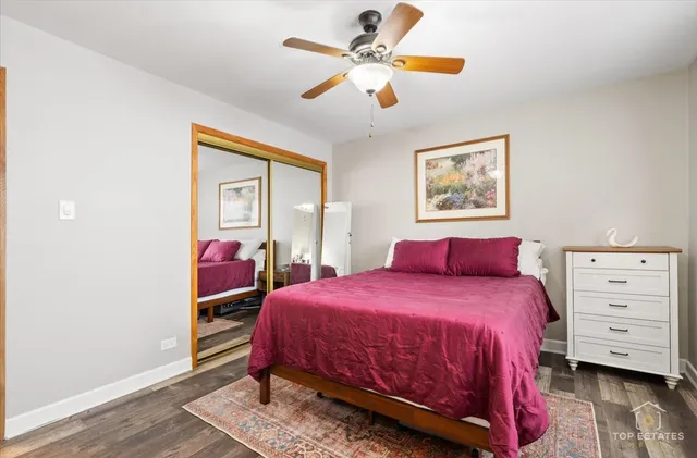 a bedroom with a bed a chandelier and a dresser