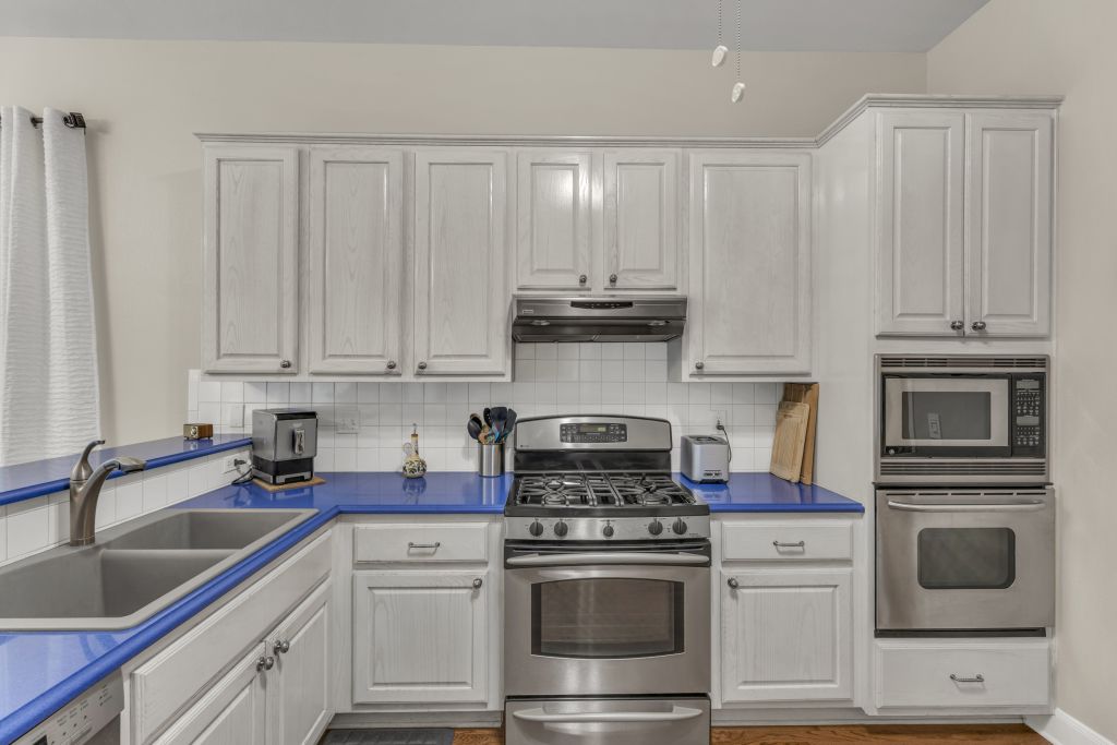 144 Cattle Trail Way Georgetown, TX 78633 - Photo 10 of 37 A functional kitchen features stainless steel appliances and ample cabinetry.