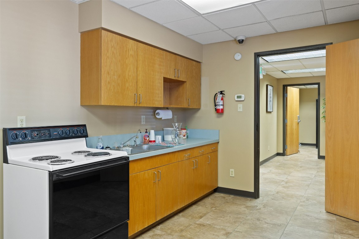 401 Main Street Blanco, TX 78606 - Photo 18 of 36 a kitchen with a sink a stove and a refrigerator