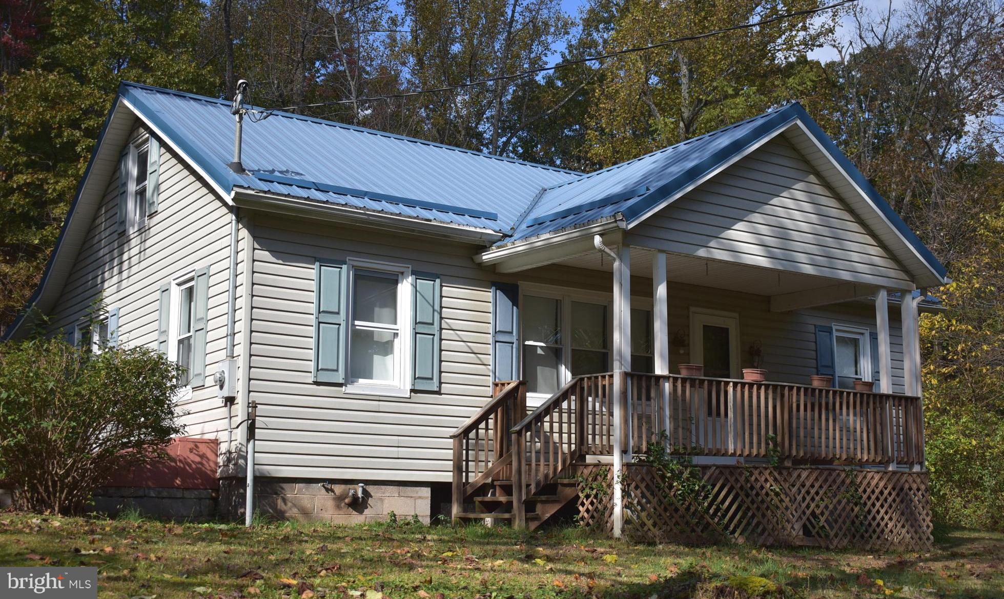 14210 Exline Road Hancock, MD 21750 - Photo 1 of 26 a view of house with a small yard and a large tree